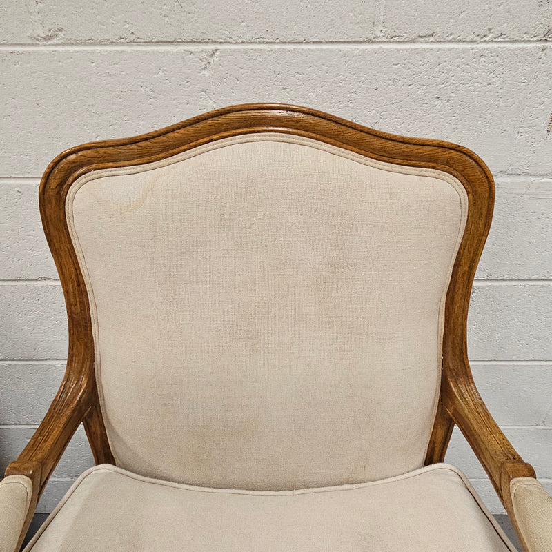 Pair of vintage Louis 15th style oak framed bergeres chairs with good size seats. making them very comfortable to sit in. The upholstery is in used condition with stains as shown in photos. Overall the timber frames are strong &amp; solid. They have been sourced directly from France. 