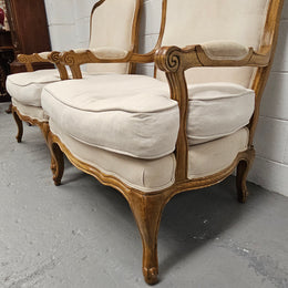 Pair of vintage Louis 15th style oak framed bergeres chairs with good size seats. making them very comfortable to sit in. The upholstery is in used condition with stains as shown in photos. Overall the timber frames are strong &amp; solid. They have been sourced directly from France. 