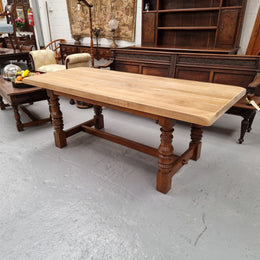 Sourced from France a solid French Oak farmhouse dining table. It features a beautiful stretcher base with turned legs and a raw oak top. The raw oak timber top could be used as is for a distressed look, or finished and waxed for a more refined look. The table very comfortably sits six people and is in good condition.