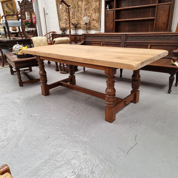 Sourced from France a solid French Oak farmhouse dining table. It features a beautiful stretcher base with turned legs and a raw oak top. The raw oak timber top could be used as is for a distressed look, or finished and waxed for a more refined look. The table very comfortably sits six people and is in good condition.