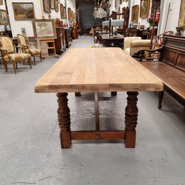 Sourced from France a solid French Oak farmhouse dining table. It features a beautiful stretcher base with turned legs and a raw oak top. The raw oak timber top could be used as is for a distressed look, or finished and waxed for a more refined look. The table very comfortably sits six people and is in good condition.