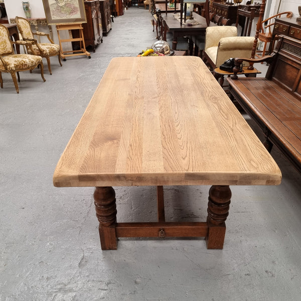 Sourced from France a solid French Oak farmhouse dining table. It features a beautiful stretcher base with turned legs and a raw oak top. The raw oak timber top could be used as is for a distressed look, or finished and waxed for a more refined look. The table very comfortably sits six people and is in good condition.