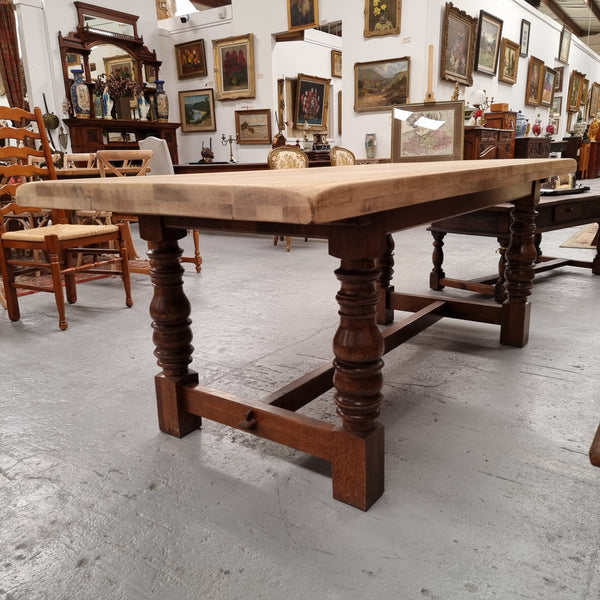 Sourced from France a solid French Oak farmhouse dining table. It features a beautiful stretcher base with turned legs and a raw oak top. The raw oak timber top could be used as is for a distressed look, or finished and waxed for a more refined look. The table very comfortably sits six people and is in good condition.