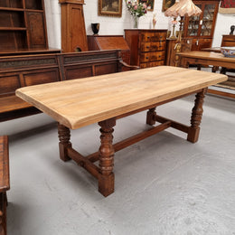 Sourced from France a solid French Oak farmhouse dining table. It features a beautiful stretcher base with turned legs and a raw oak top. The raw oak timber top could be used as is for a distressed look, or finished and waxed for a more refined look. The table very comfortably sits six people and is in good condition.