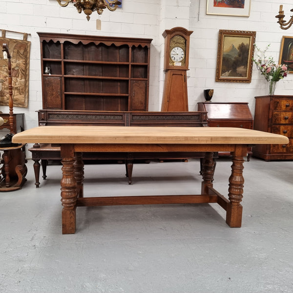 Sourced from France a solid French Oak farmhouse dining table. It features a beautiful stretcher base with turned legs and a raw oak top. The raw oak timber top could be used as is for a distressed look, or finished and waxed for a more refined look. The table very comfortably sits six people and is in good condition.