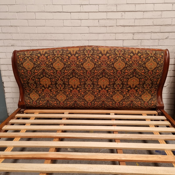 Vintage Empire style hard to find king Size bed with impressive tapestry upholstery. It comes with custom made bed slats ready to simple place your standard king size mattress on top. It is in good original detailed condition. The tapestry upholstery is in good condition and is upholstered on the back as well.