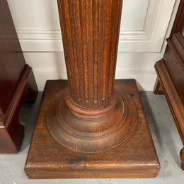 Edwardian oak pedestal with square top and base and featuring a fluted column. In good original condition. 