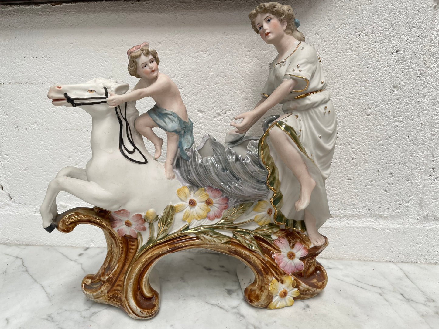 Beautiful Victorian bisque figurine group of a boy and lady riding a white horse. It is in good original condition. Please see photos as they form part of the description.