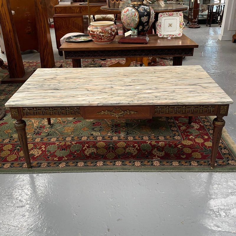 Impressive Louis XVI style walnut coffee table. Stunning marble top, gilt mounts and fluted legs. Circa: 1950's. In good original condition.