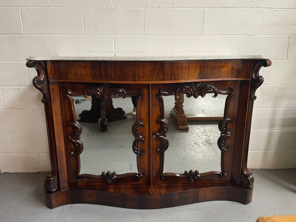 Antique English Rosewood marble top credenza. Featuring two beautiful mirrored doors and a lovely serpentine shaped front. Sourced locally and in good original detailed condition.