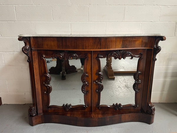 Antique English Rosewood marble top credenza. Featuring two beautiful mirrored doors and a lovely serpentine shaped front. Sourced locally and in good original detailed condition.