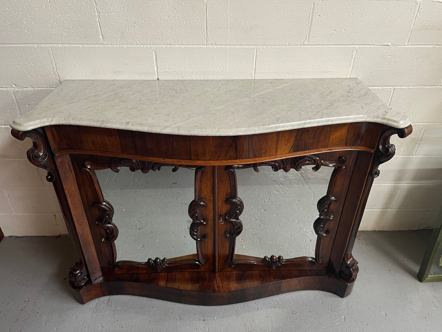 Antique English Rosewood marble top credenza. Featuring two beautiful mirrored doors and a lovely serpentine shaped front. Sourced locally and in good original detailed condition.