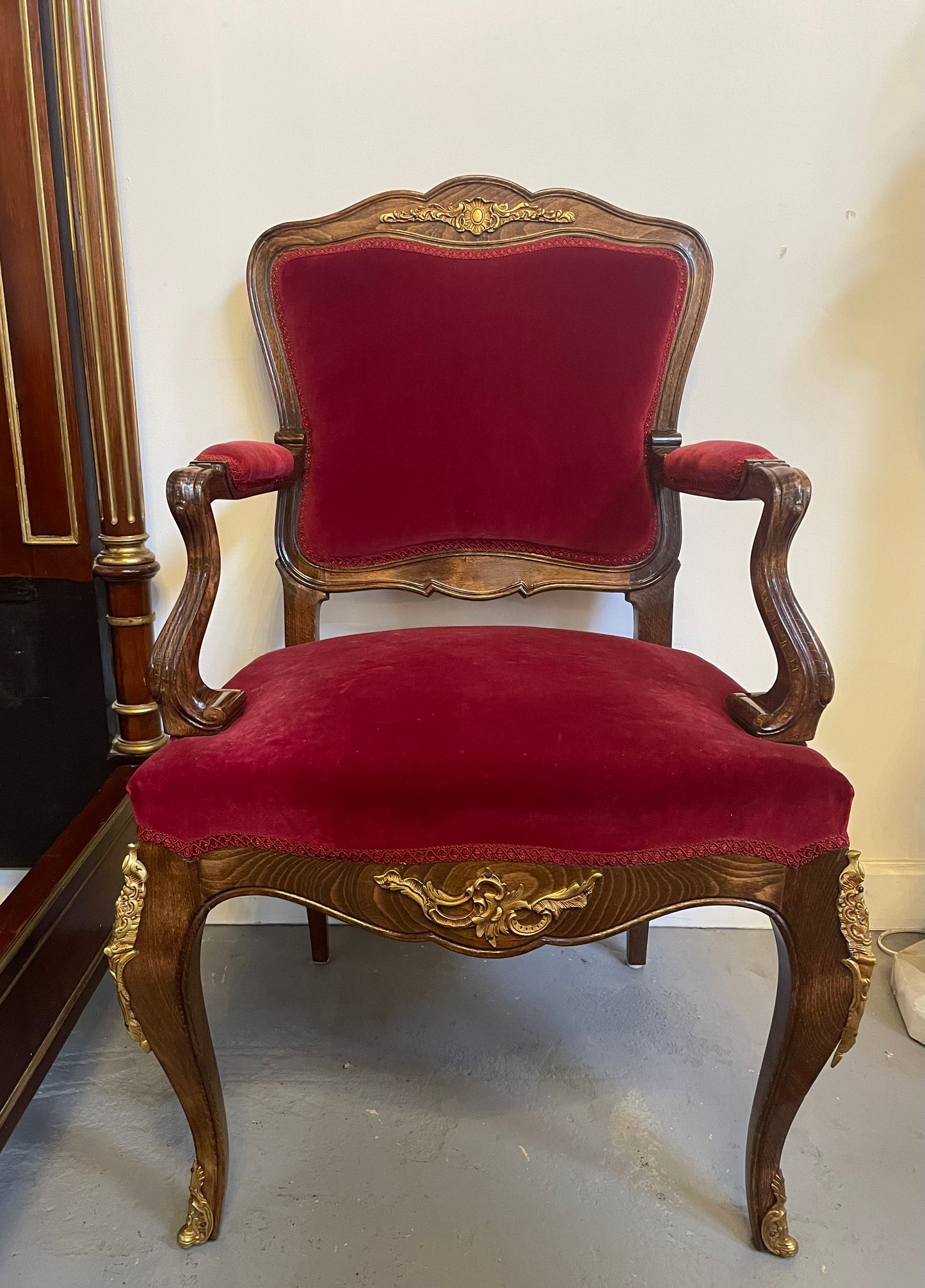 Louis XV style French Walnut armchair/desk chair with red valet upholstery. Fabric is in good condition with some signs of use and features beautiful decorative mounts. It has been sourced from France and is in good original detailed condition. 