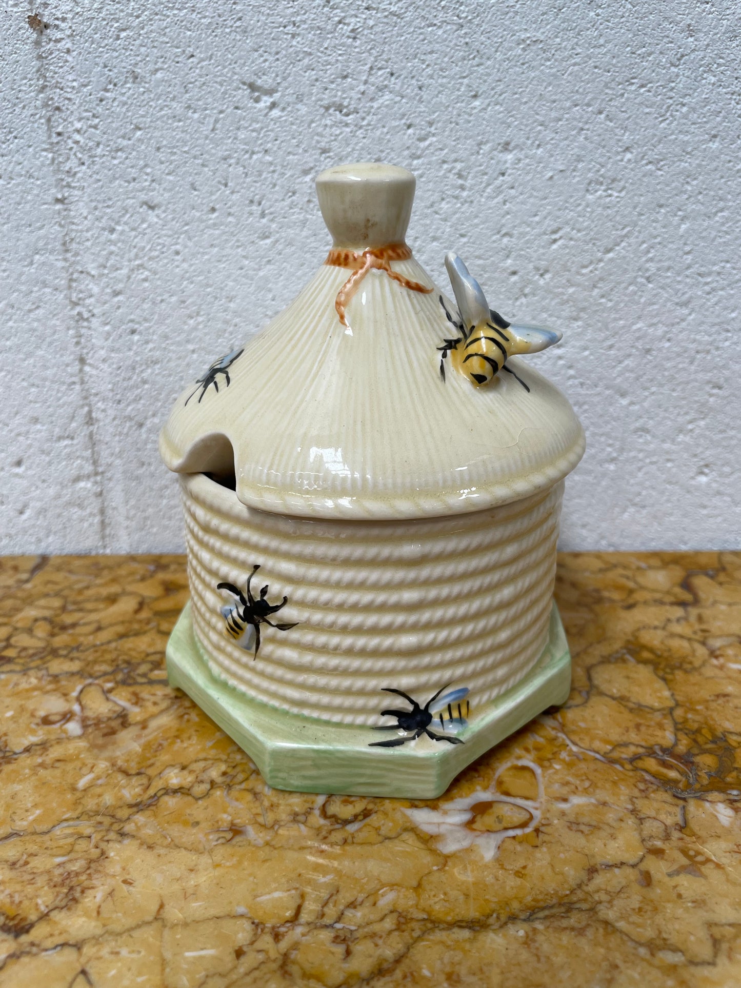 Lovely textured Crown Devon beehive marked Made in England to the base. It has several bees painted. There are some crazing to the base. It is in good original condition.