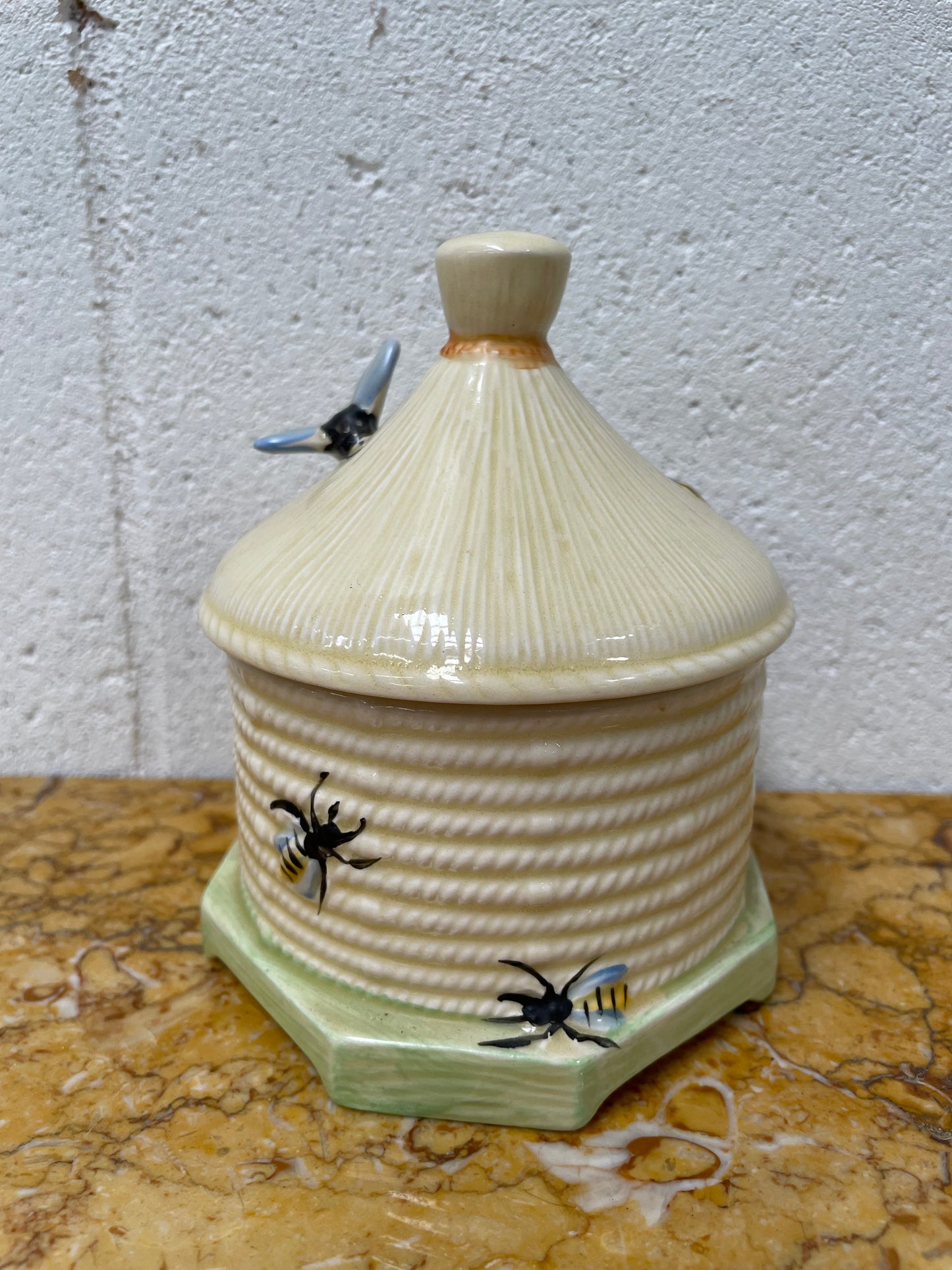 Lovely textured Crown Devon beehive marked Made in England to the base. It has several bees painted. There are some crazing to the base. It is in good original condition.