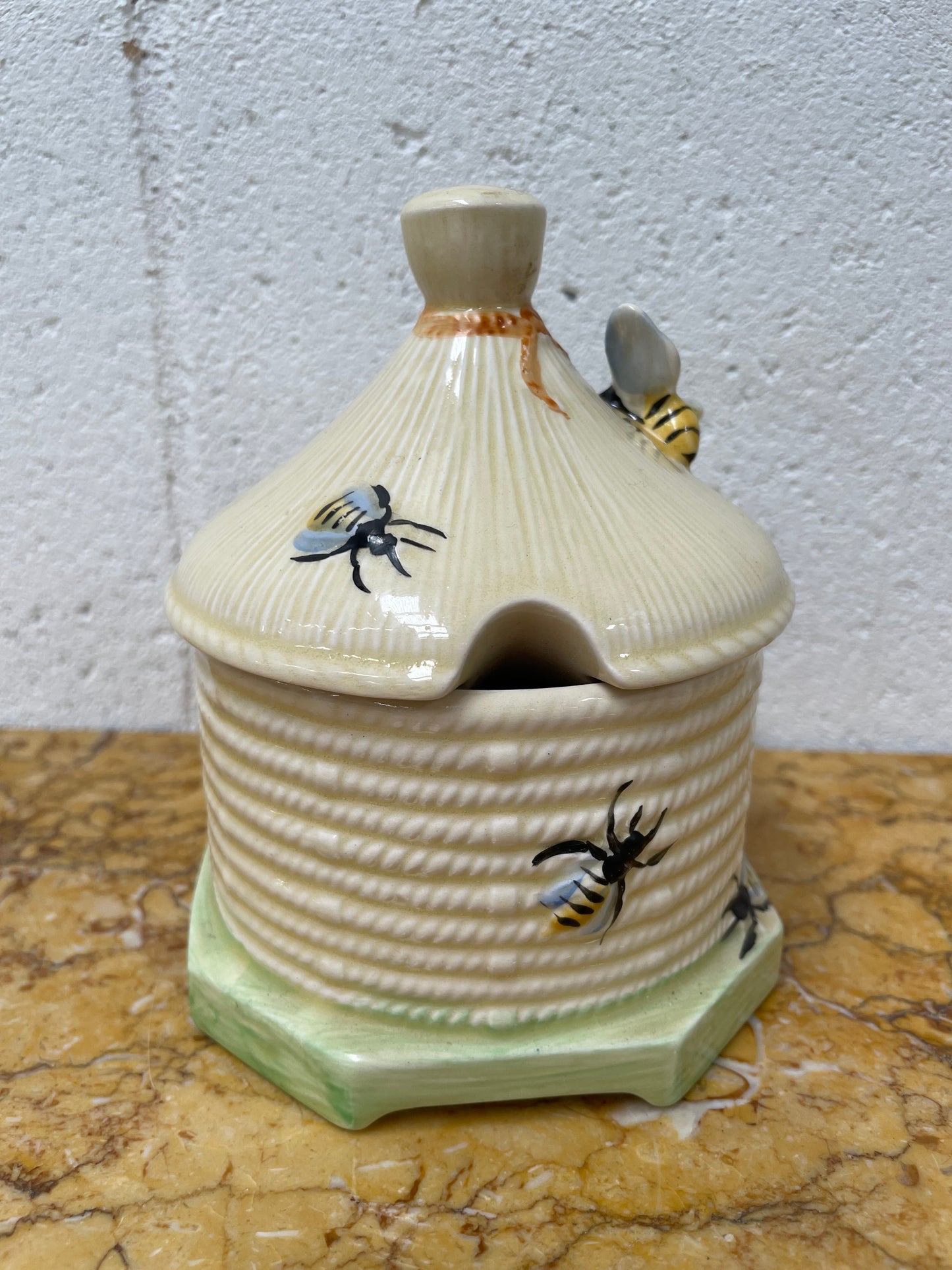 Lovely textured Crown Devon beehive marked Made in England to the base. It has several bees painted. There are some crazing to the base. It is in good original condition.