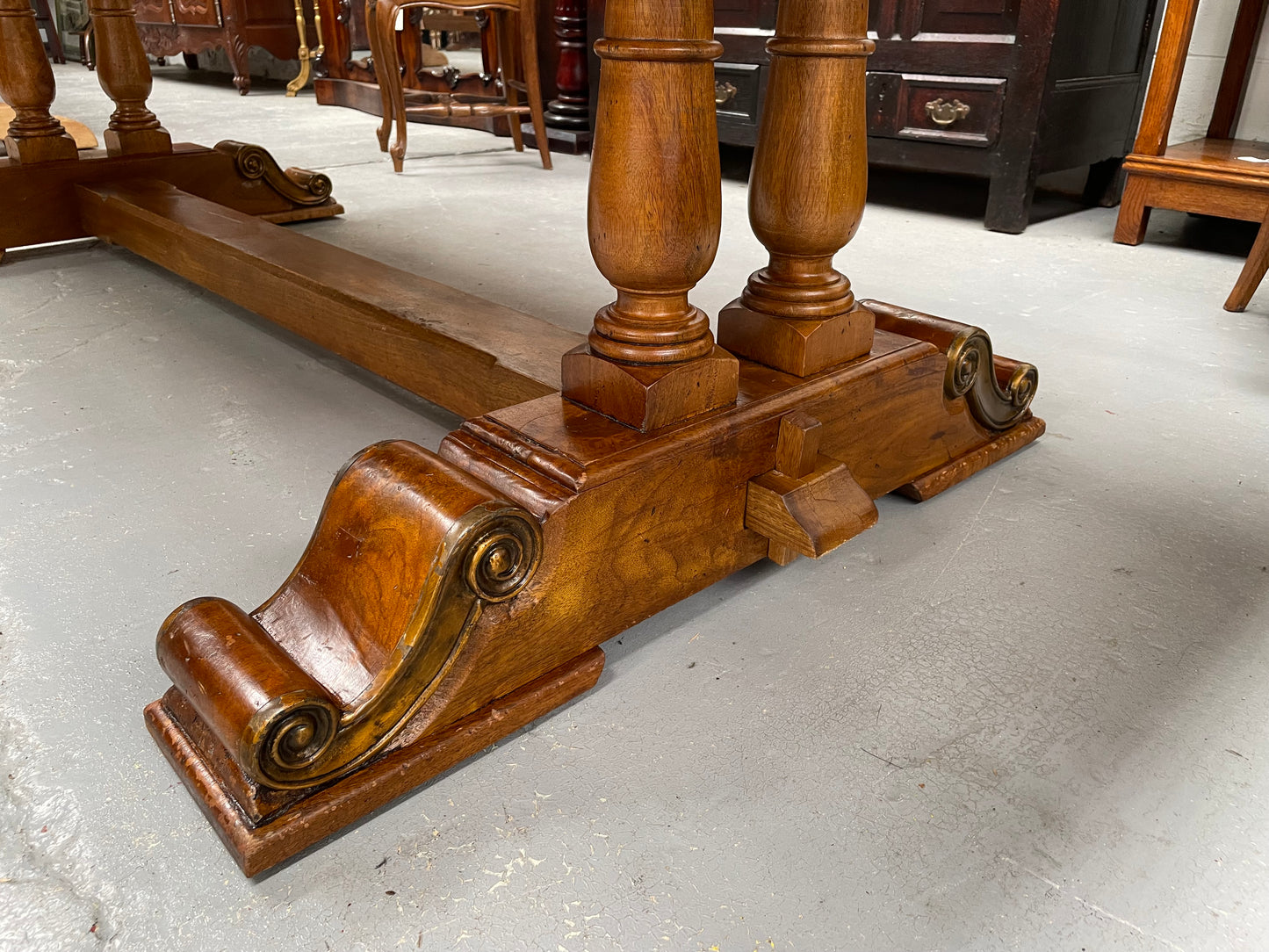 Vintage reclaimed Mahogany parquetry top monastery style dining table. It features beautiful brass mounts on the feet of the table and is in good original detailed condition. It can comfortably seat eight people. 