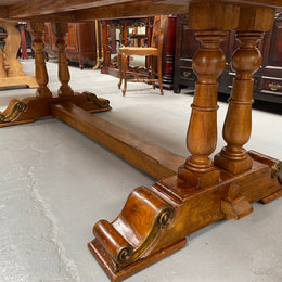 Vintage reclaimed Mahogany parquetry top monastery style dining table. It features beautiful brass mounts on the feet of the table and is in good original detailed condition. It can comfortably seat eight people. 