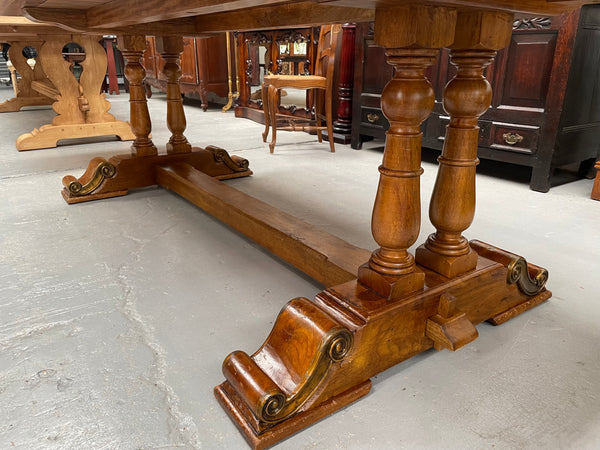 Vintage reclaimed Mahogany parquetry top monastery style dining table. It features beautiful brass mounts on the feet of the table and is in good original detailed condition. It can comfortably seat eight people. 