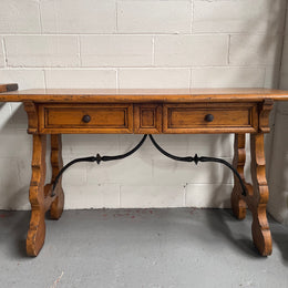 Walnut Spanish style two drawer console table. Features beautiful iron work and is in good original detailed condition.