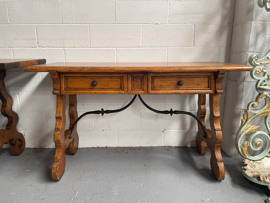 Walnut Spanish style two drawer console table. Features beautiful iron work and is in good original detailed condition.