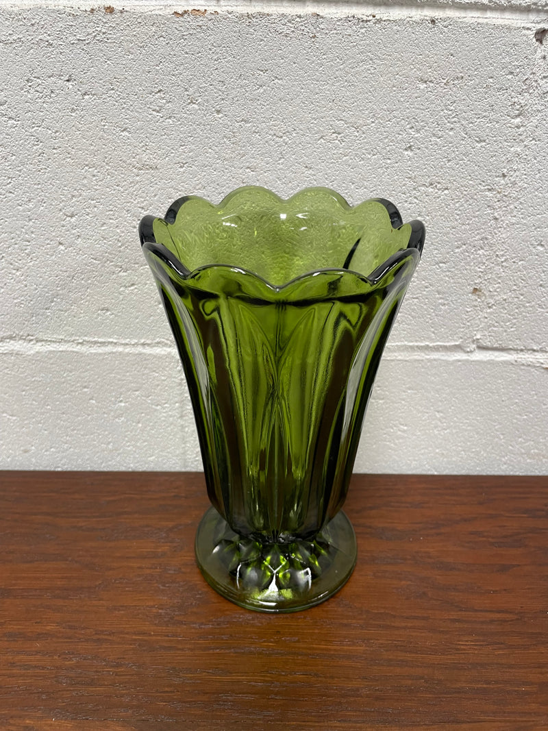 Lovely vintage green glass vase with a pretty scalloped edge and good height for flowers.