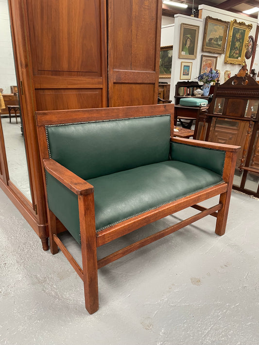 Rustic Arts and Crafts upholstered green bench seat. Made of English oak and very comfortable to sit on. In good original condition. Please see all photos as they form part of the description and condition.