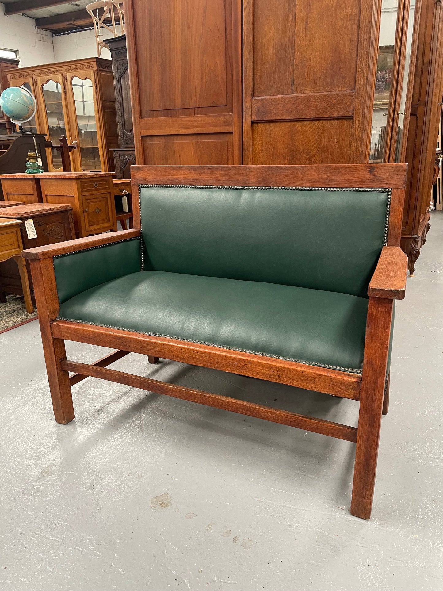 Rustic Arts and Crafts upholstered green bench seat. Made of English oak and very comfortable to sit on. In good original condition. Please see all photos as they form part of the description and condition.