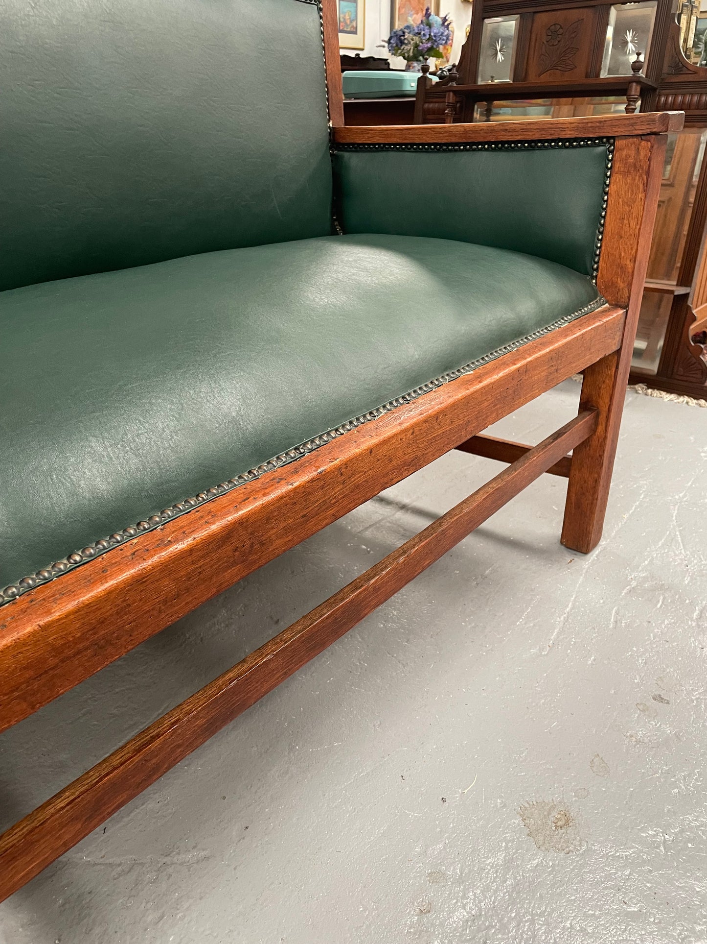 Rustic Arts and Crafts upholstered green bench seat. Made of English oak and very comfortable to sit on. In good original condition. Please see all photos as they form part of the description and condition.