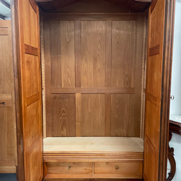 French Walnut Louis XV style two mirrored door armoire. It has four full adjustable shelves and two drawers at the bottom with one that locks. It has been sourced directly from France and is in good original detailed condition.