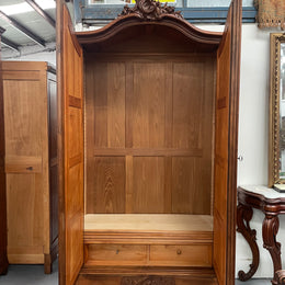 French Walnut Louis XV style two mirrored door armoire. It has four full adjustable shelves and two drawers at the bottom with one that locks. It has been sourced directly from France and is in good original detailed condition.