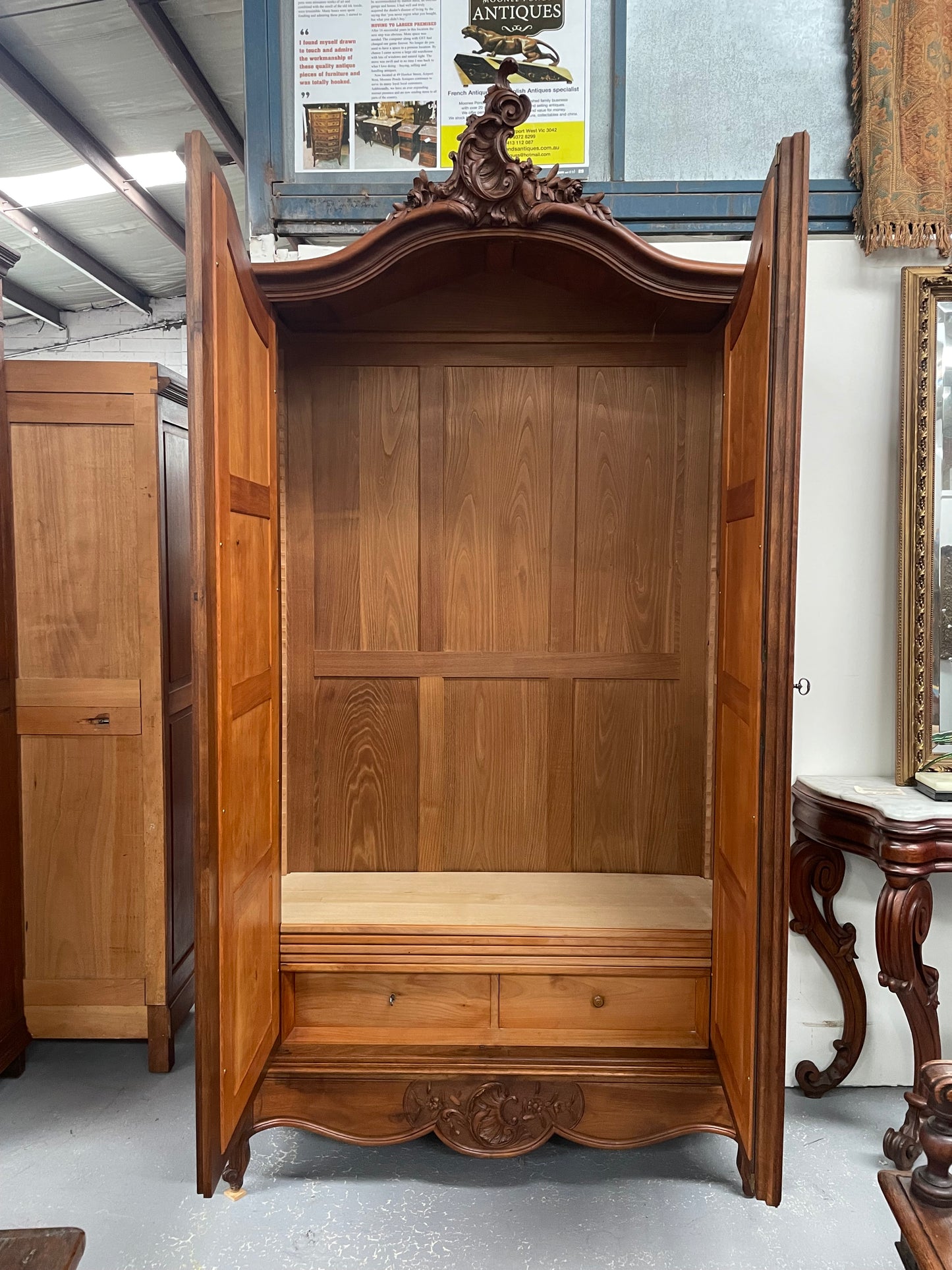 French Walnut Louis XV style two mirrored door armoire. It has four full adjustable shelves and two drawers at the bottom with one that locks. It has been sourced directly from France and is in good original detailed condition.