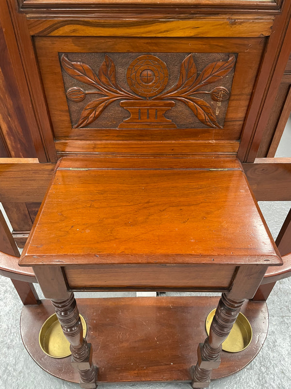 Lovely Edwardian walnut stand with six brass hooks and a storage box with lift up lid . Very nice carving to back and in good original condition. Please view photos as they help to form part of the description and condition.