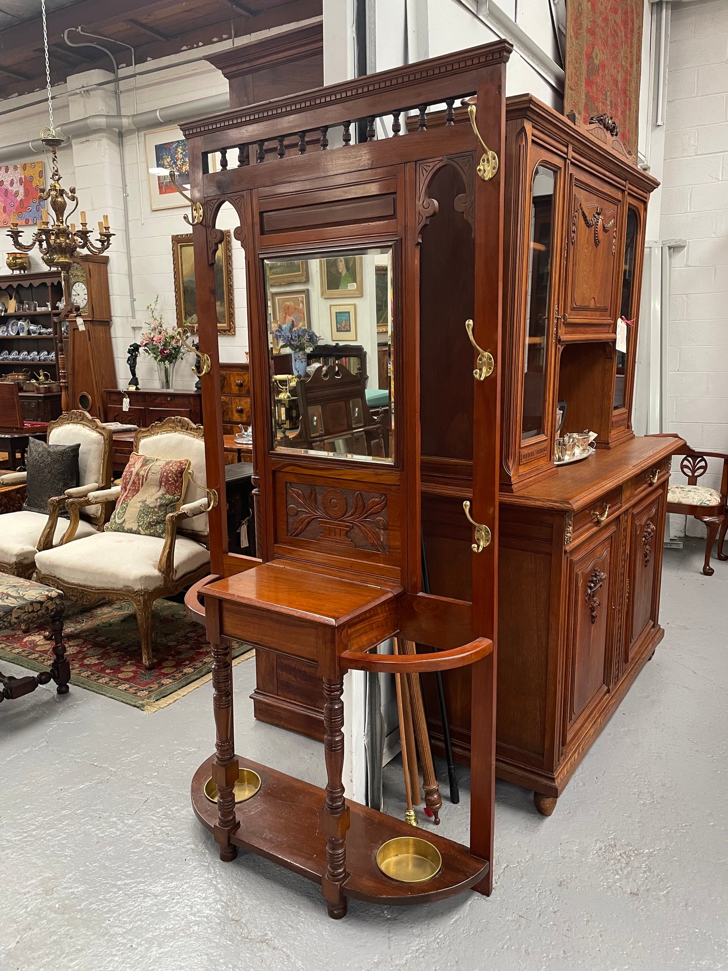 Lovely Edwardian walnut stand with six brass hooks and a storage box with lift up lid . Very nice carving to back and in good original condition. Please view photos as they help to form part of the description and condition.