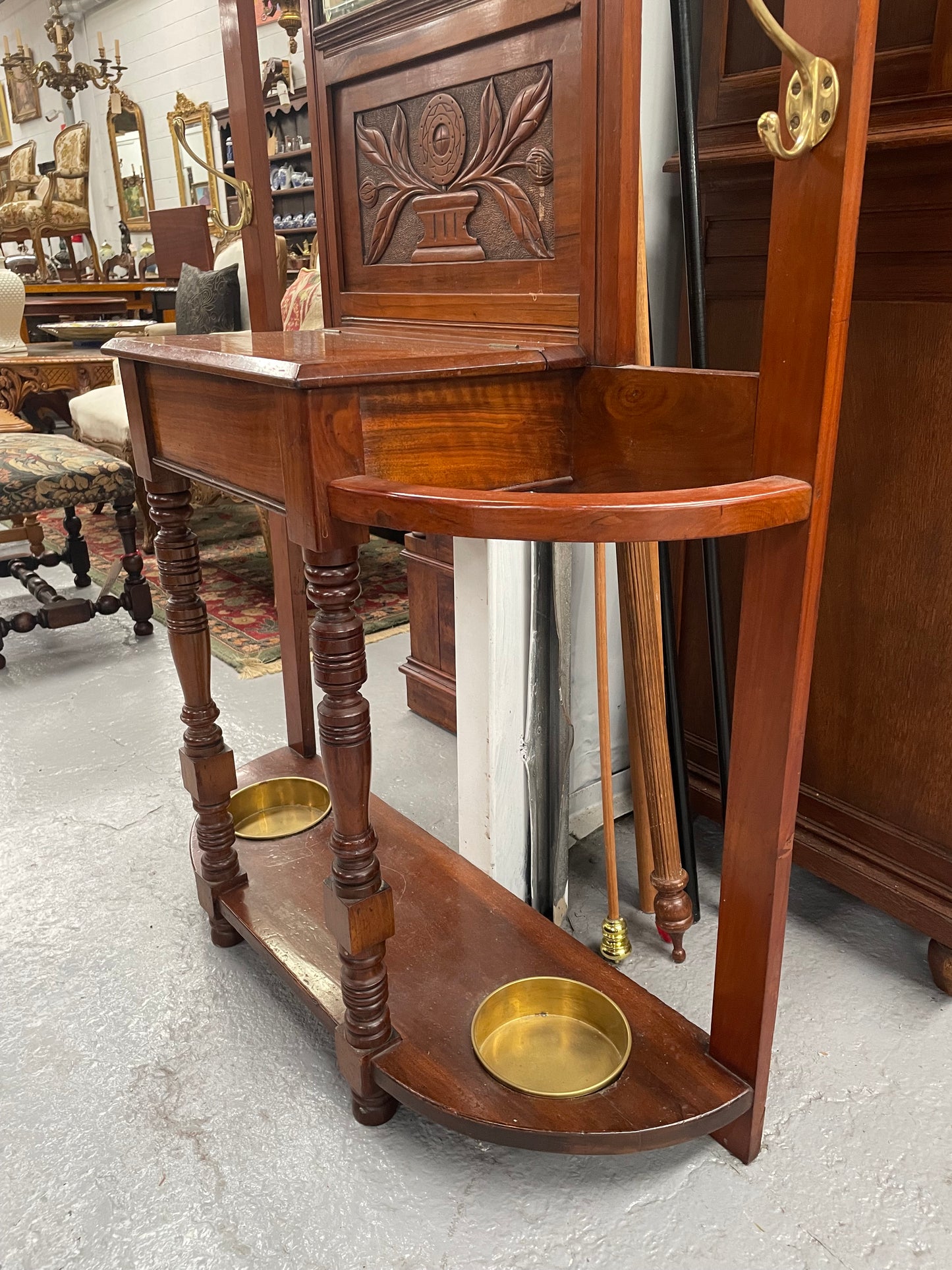 Lovely Edwardian walnut stand with six brass hooks and a storage box with lift up lid . Very nice carving to back and in good original condition. Please view photos as they help to form part of the description and condition.