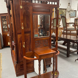 Lovely Edwardian walnut stand with six brass hooks and a storage box with lift up lid . Very nice carving to back and in good original condition. Please view photos as they help to form part of the description and condition.