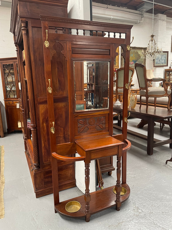 Lovely Edwardian walnut stand with six brass hooks and a storage box with lift up lid . Very nice carving to back and in good original condition. Please view photos as they help to form part of the description and condition.