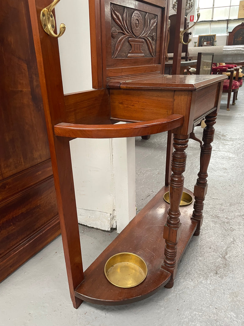 Lovely Edwardian walnut stand with six brass hooks and a storage box with lift up lid . Very nice carving to back and in good original condition. Please view photos as they help to form part of the description and condition.