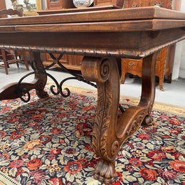 Beautiful French Oak Spanish style extension dining table with a decorative iron base and parquetry top. Lovely carvings on the legs and the skirt of the base.  With the extensions closed it is 160 cm long and when fully extended it is 268 cm long. It has been sourced from France and in good original condition.