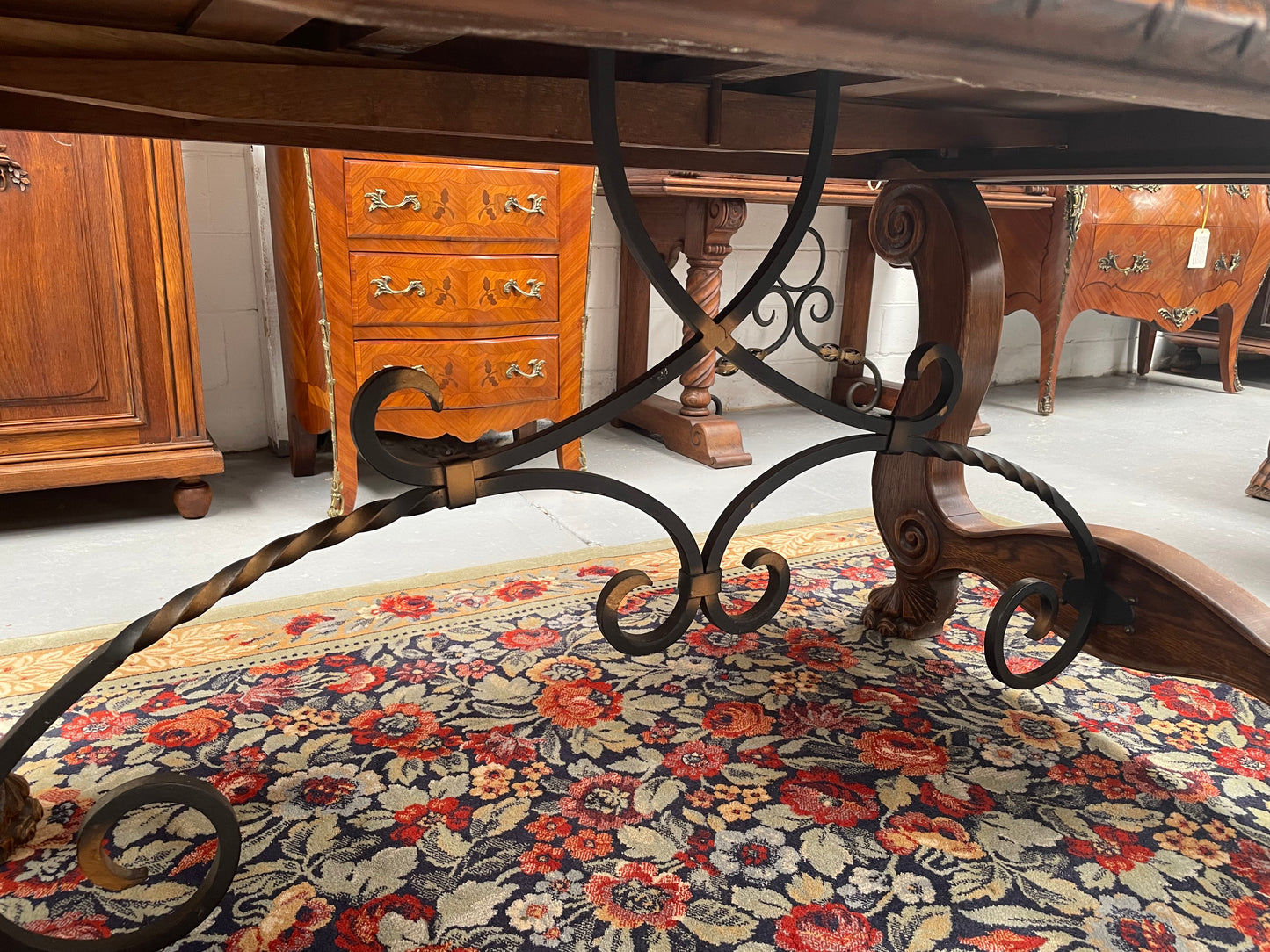 Beautiful French Oak Spanish style extension dining table with a decorative iron base and parquetry top. Lovely carvings on the legs and the skirt of the base.  With the extensions closed it is 160 cm long and when fully extended it is 268 cm long. It has been sourced from France and in good original condition.