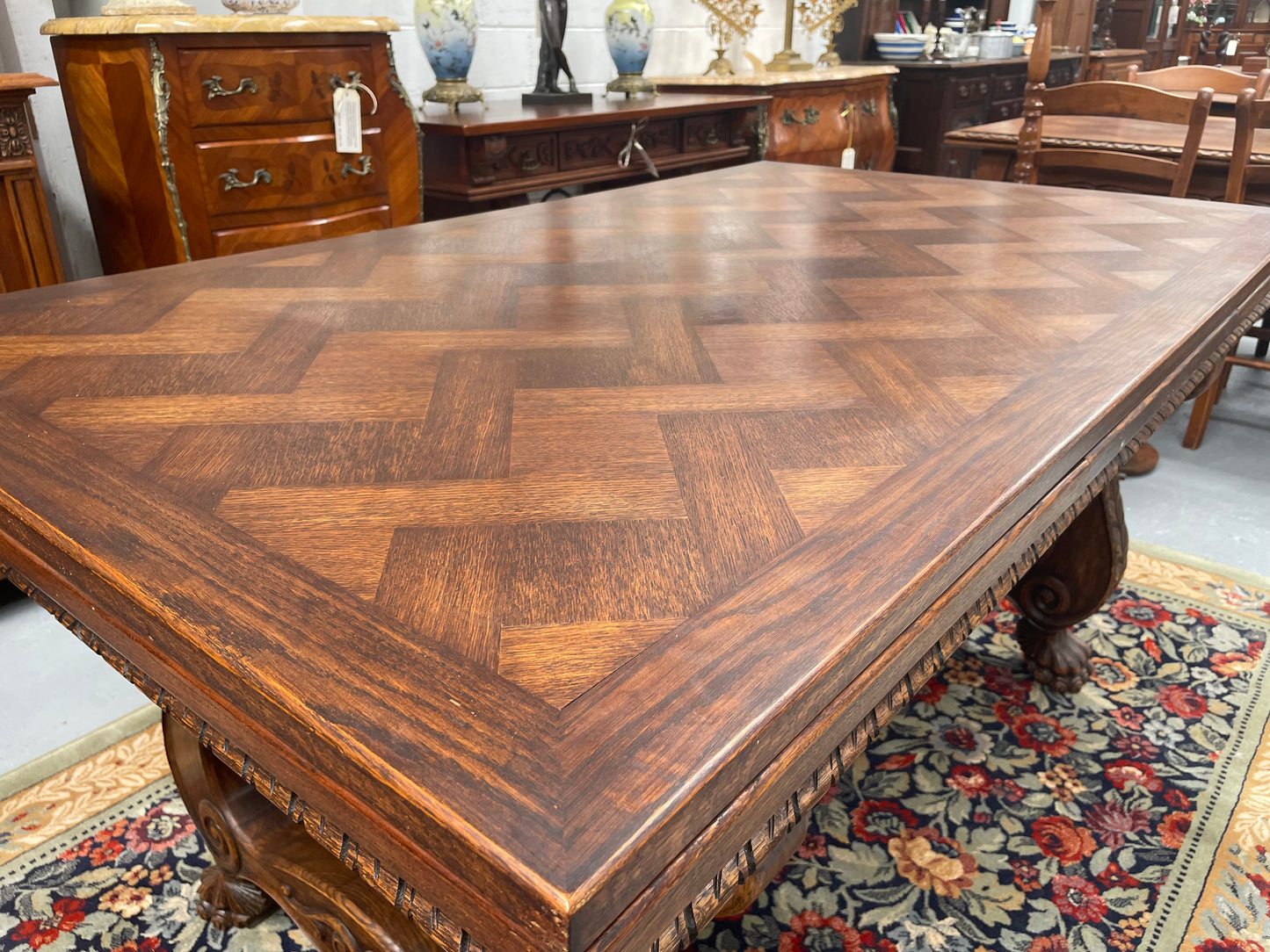 Beautiful French Oak Spanish style extension dining table with a decorative iron base and parquetry top. Lovely carvings on the legs and the skirt of the base.  With the extensions closed it is 160 cm long and when fully extended it is 268 cm long. It has been sourced from France and in good original condition.