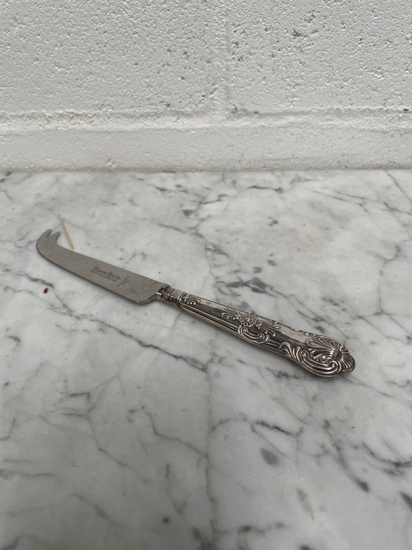 Decorative Sheffield sterling silver cheese knife. The handle has sterling silver hallmarks and the blade is stainless steel. Made in England and is in good original condition.