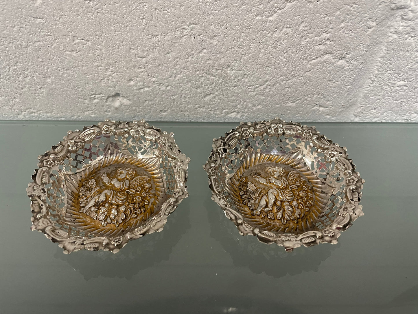 Lovely pair of sterling silver and silver gilt Edwardian bon bon dishes with decorative cherubs and in good original condition. Please see photos as they form part of the description.