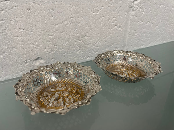 Lovely pair of sterling silver and silver gilt Edwardian bon bon dishes with decorative cherubs and in good original condition. Please see photos as they form part of the description.