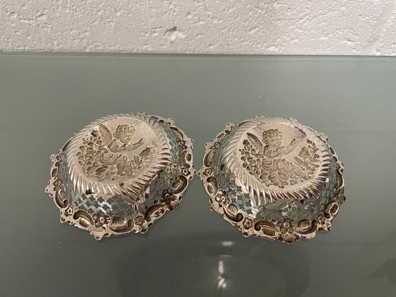 Lovely pair of sterling silver and silver gilt Edwardian bon bon dishes with decorative cherubs and in good original condition. Please see photos as they form part of the description.