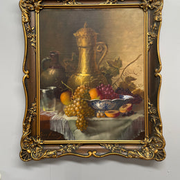 Beautiful oil on canvas on board painting of a bowl of fruit and jug on table, signed by Dutch artist. Framed in an ornate gilt frame and in good original condition.