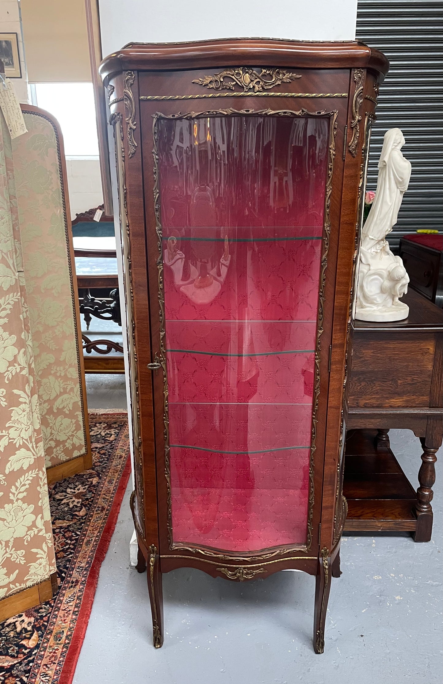Beautiful French Louis XV style Walnut and bronze mounted vitrine with fabric interior and glass shelves. Sourced from France and in good original detailed condition.