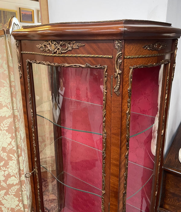 Beautiful French Louis XV style Walnut and bronze mounted vitrine with fabric interior and glass shelves. Sourced from France and in good original detailed condition.