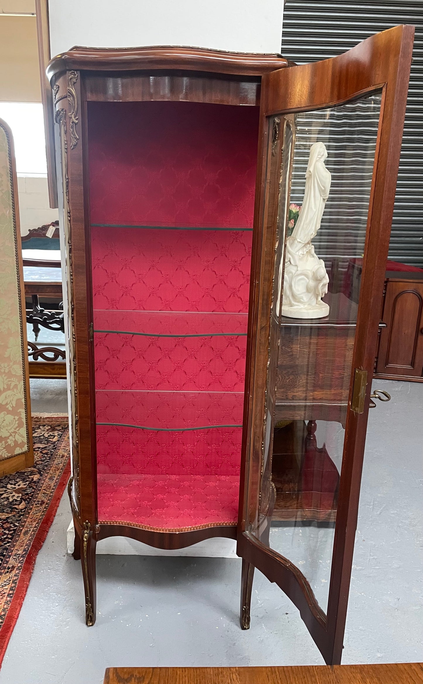 Beautiful French Louis XV style Walnut and bronze mounted vitrine with fabric interior and glass shelves. Sourced from France and in good original detailed condition.