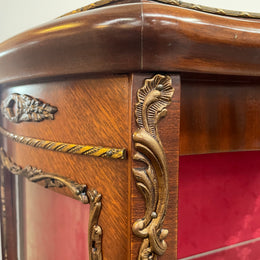 Beautiful French Louis XV style Walnut and bronze mounted vitrine with fabric interior and glass shelves. Sourced from France and in good original detailed condition.